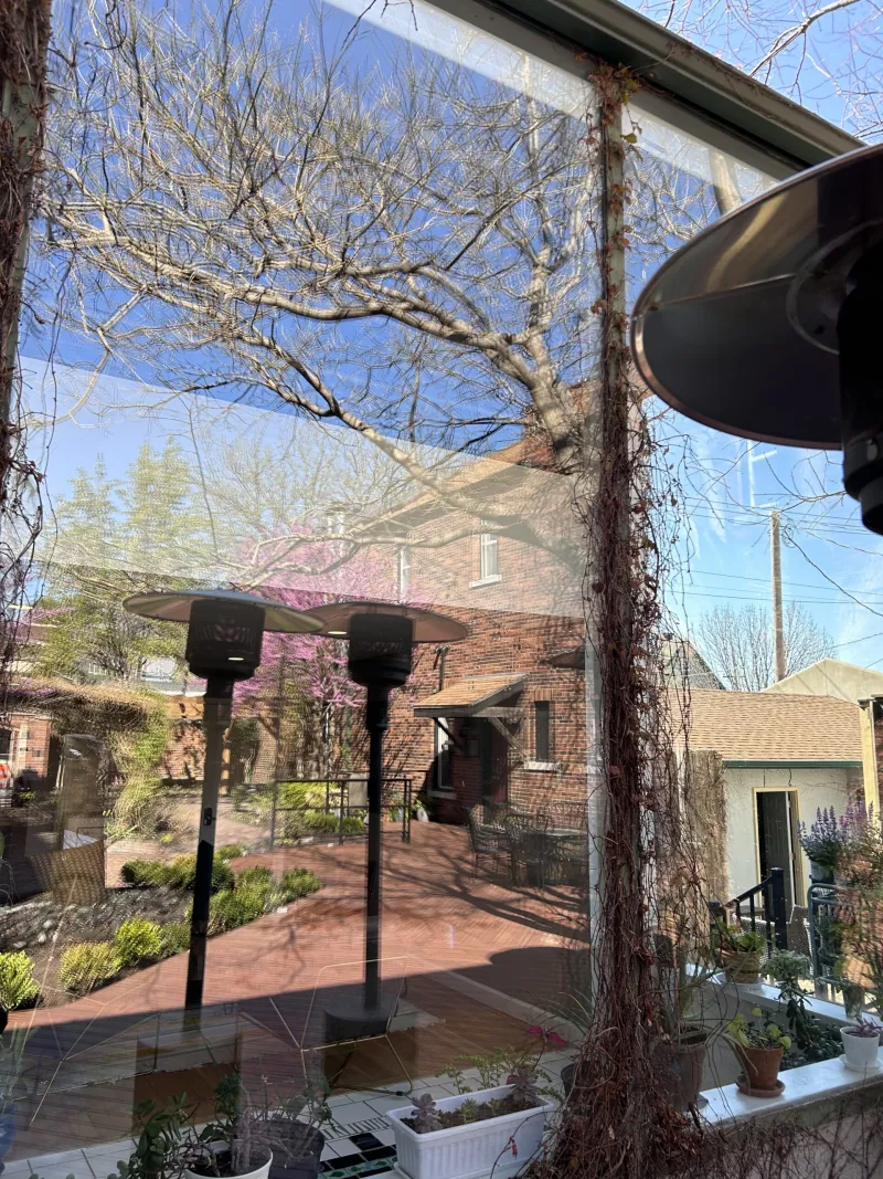 Freshly cleaned patio window reflecting a courtyard in Omaha
